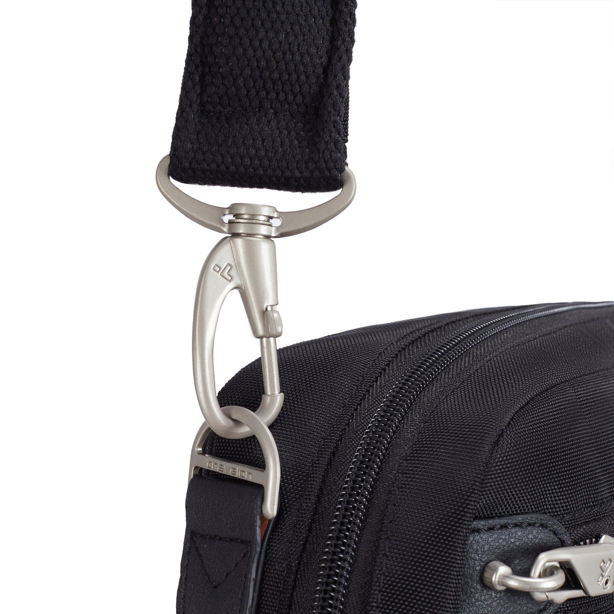 Close-up of a silver clasp on the Travelon Anti-theft Heritage Tour Bag’s slash-resistant black strap.