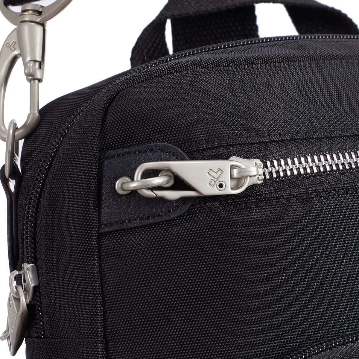 Close-up of the Travelon Anti-theft Heritage Tour Bag with silver zipper, metal clasp, and slash-resistant strap.