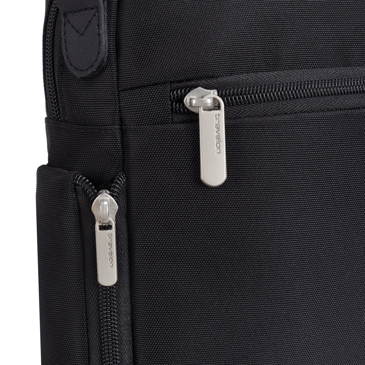 Close-up of the Travelon Anti-theft Heritage Tour Bag with silver zippers and Travelon logo on the pulls.