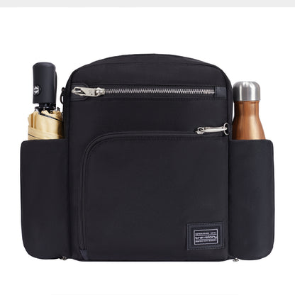 Travelon Anti-theft Heritage Tour Bag holds a beige umbrella and steel bottle in side compartments.