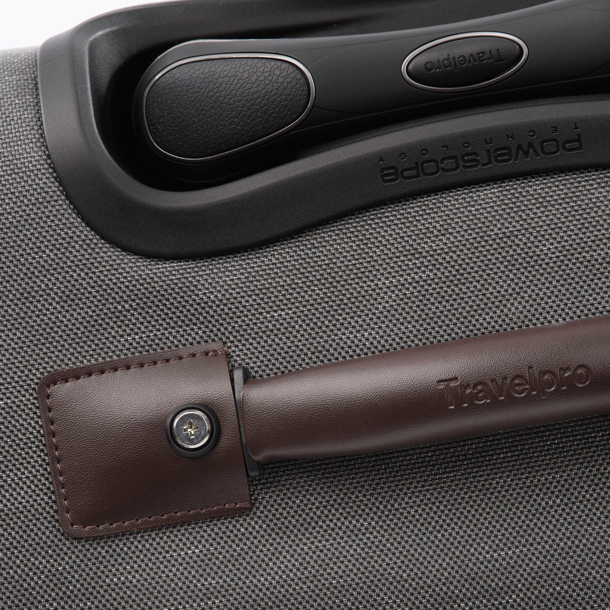 Close up of brown leather grab handle on top of the vintage grey Travelpro® Platinum® Elite 29" Expandable Spinner