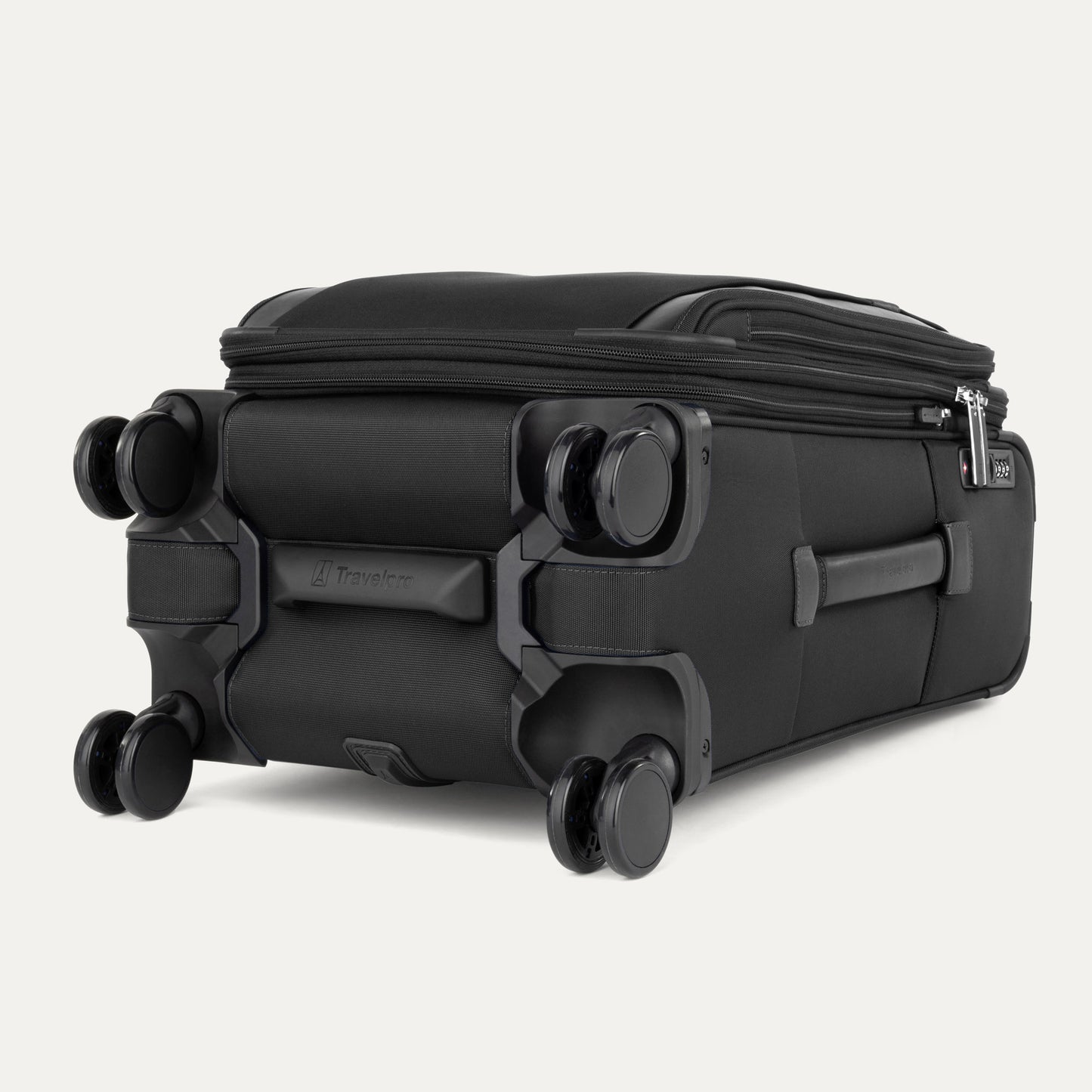 The Travelpro® VersaPack®+ black carry-on spinner, shown flat on its side, features four double wheels.