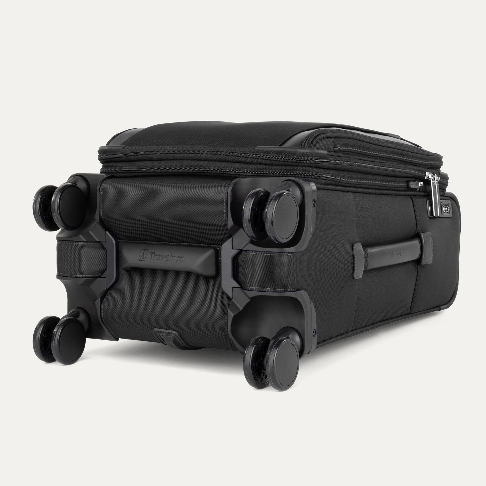The Travelpro® VersaPack®+ black carry-on spinner, shown flat on its side, features four double wheels.