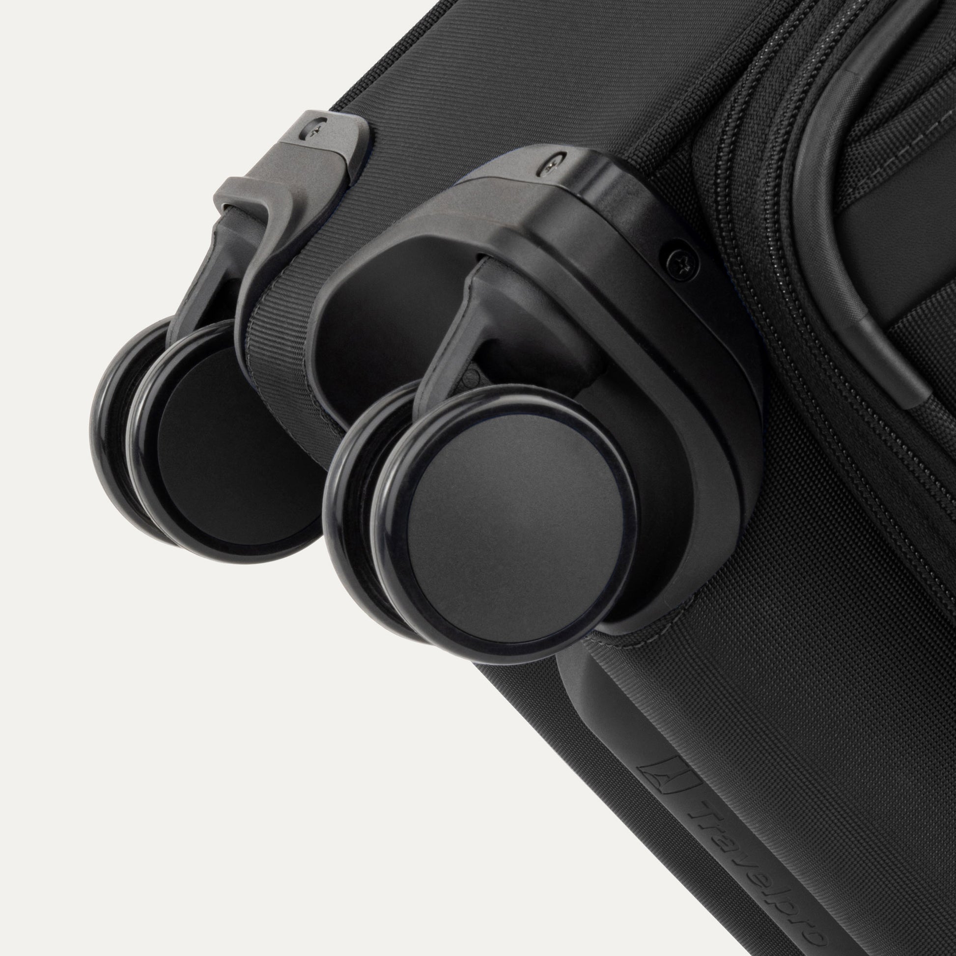 Close-up of two black spinner wheels on the Travelpro VersaPack+ Carry-on Expandable Spinner suitcase.