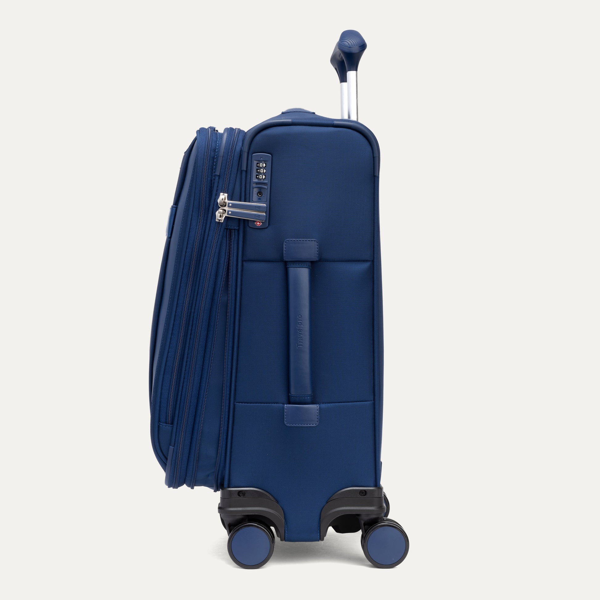 Side view of Travelpro VersaPack+ blue carry-on expandable spinner with 4 wheels and TSA lock.