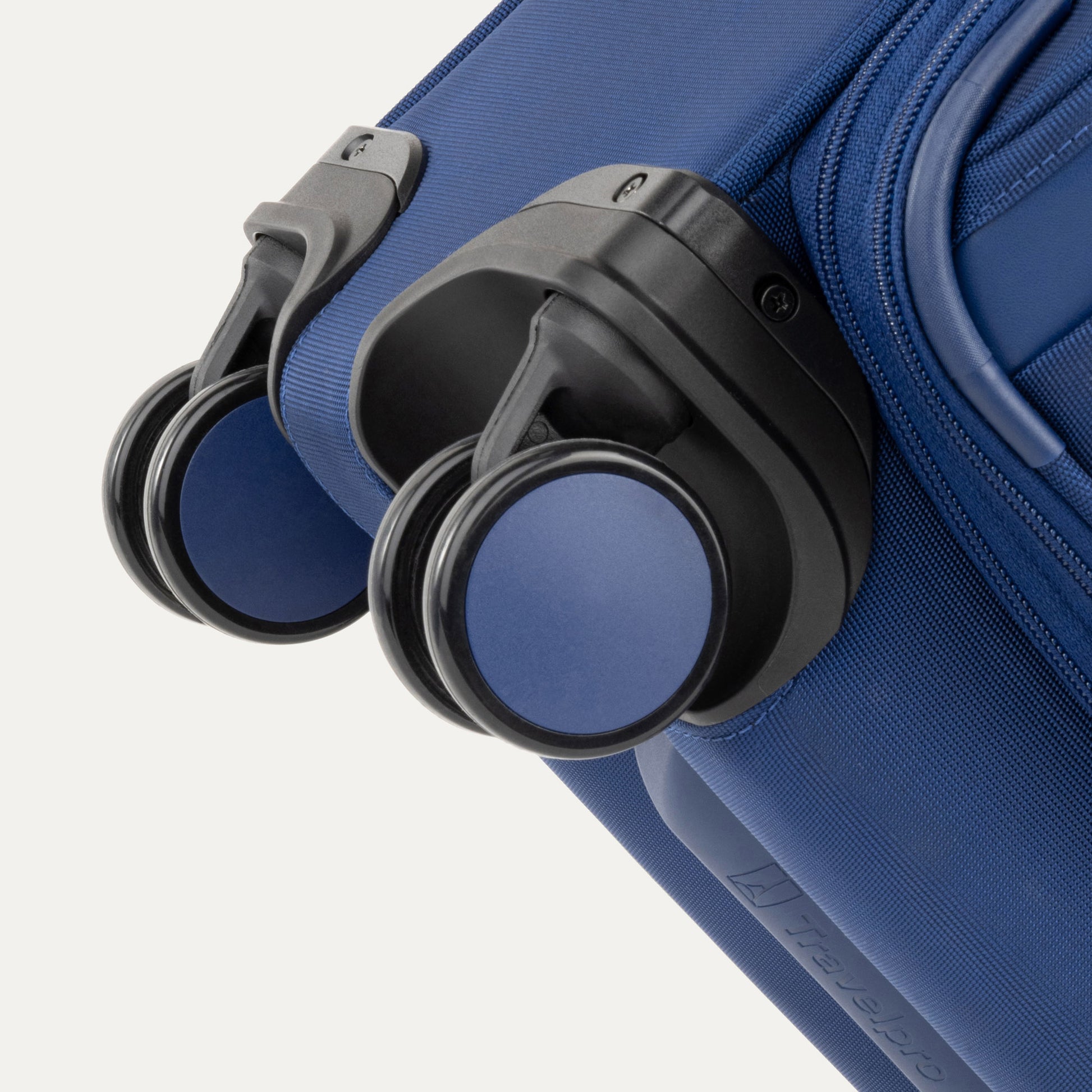 Close-up of Travelpro VersaPack+ Carry-on Expandable Spinner wheels attached to blue hard-shell case.
