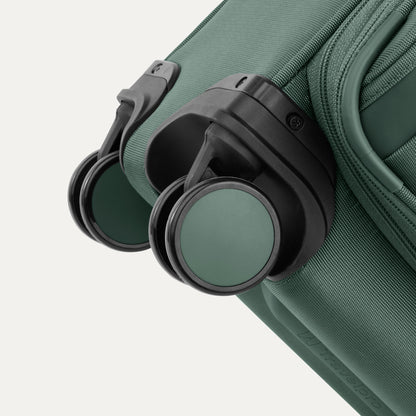 Close-up of dual spinner wheels on the Travelpro® VersaPack®+ Carry-on, highlighting sturdy wheel housing.