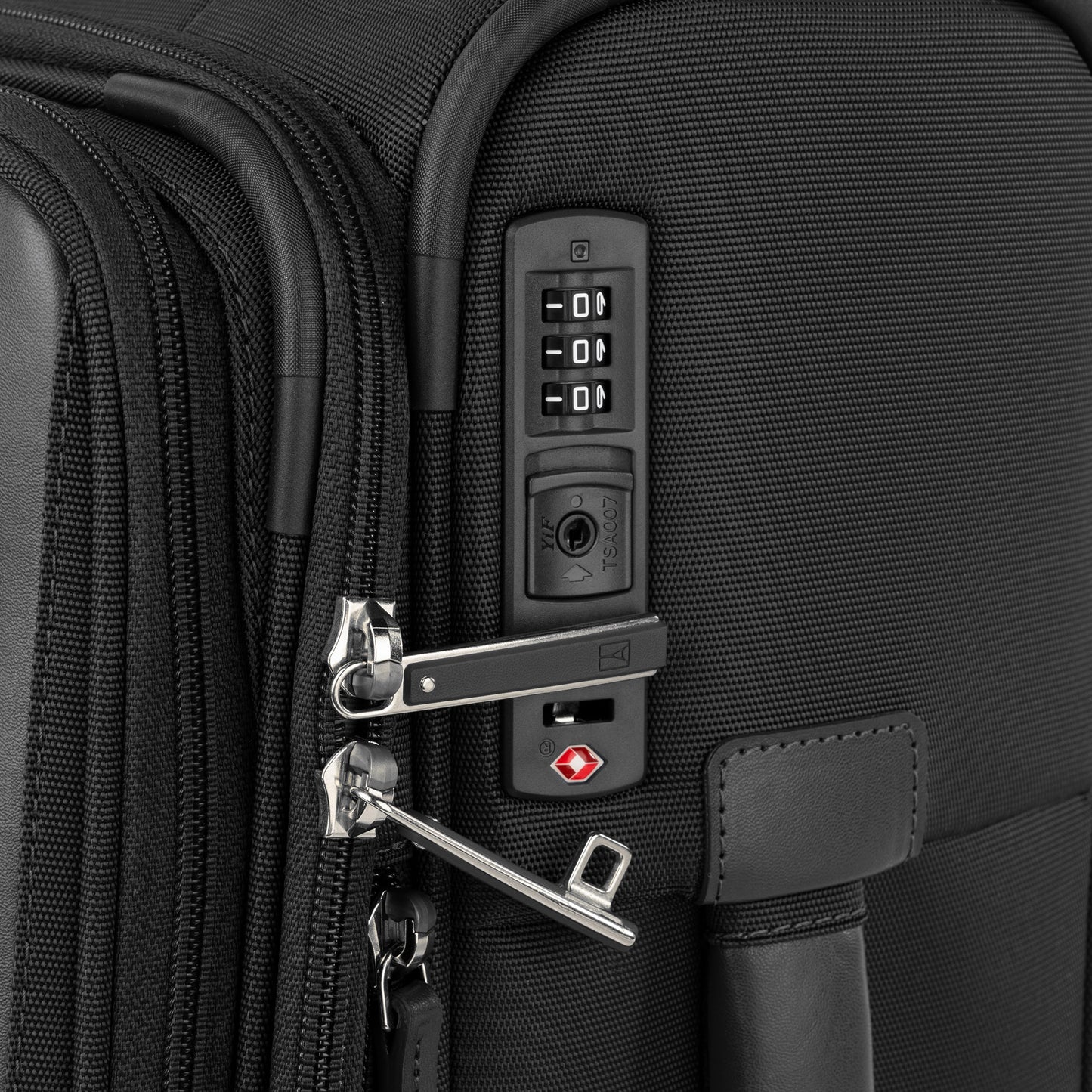 Close-up of Travelpro VersaPack+ Carry-on Spinner showing TSA combo lock securing both zipper pulls.