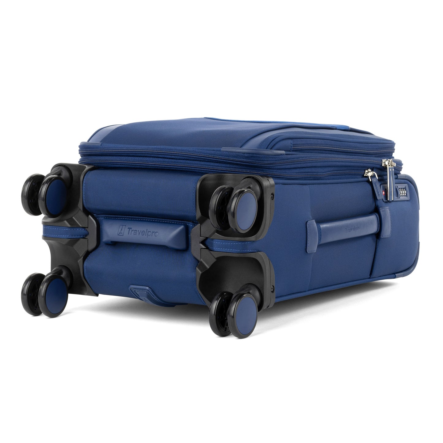 The Travelpro VersaPack+ Compact Carry-on Spinner in blue lays flat, featuring double wheels and zipper compartments.