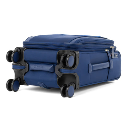 The Travelpro VersaPack+ Compact Carry-on Spinner in blue lays flat, featuring double wheels and zipper compartments.