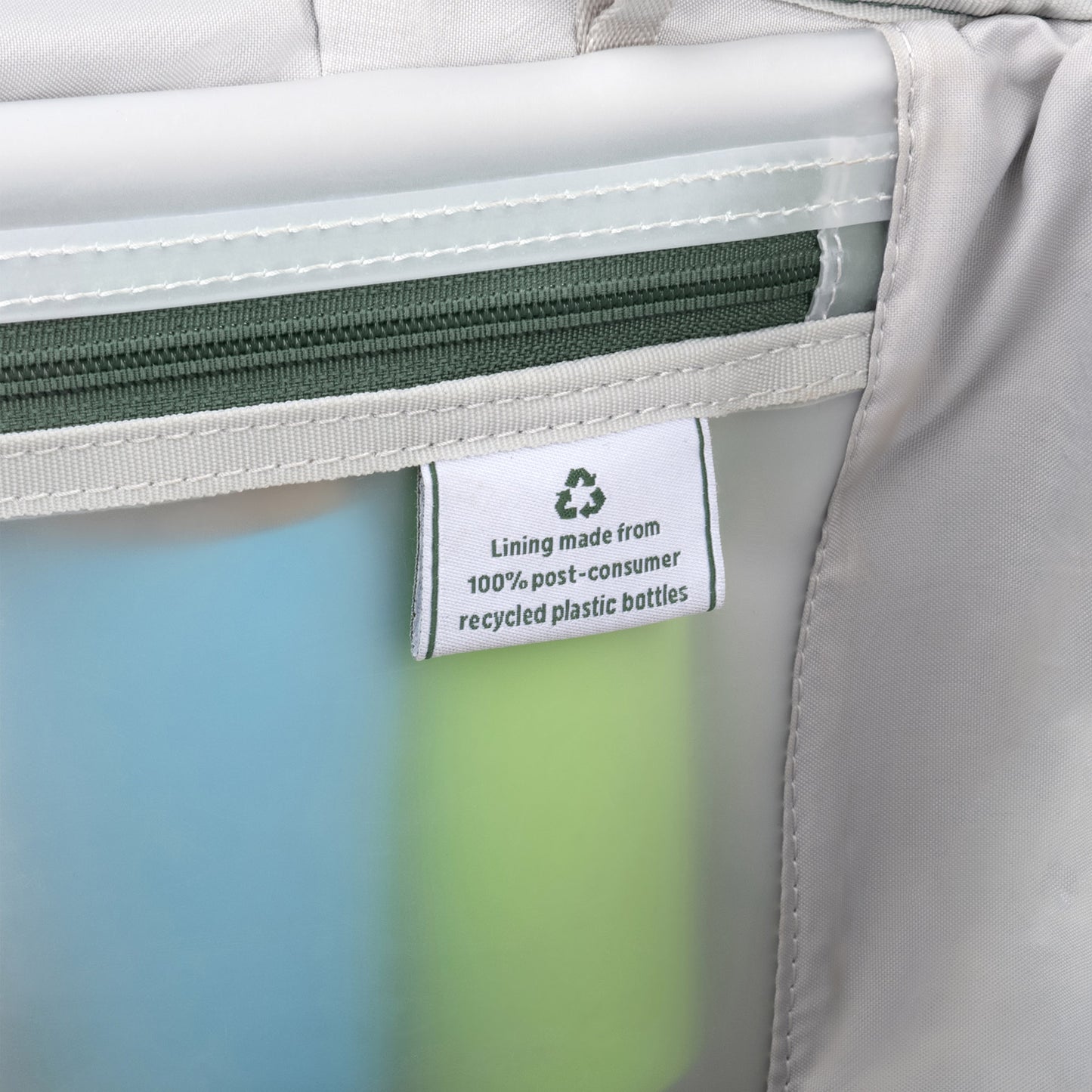 Close-up of a tag: Travelpro® VersaPack®+ carry-on’s lining is made from 100% recycled plastic bottles.