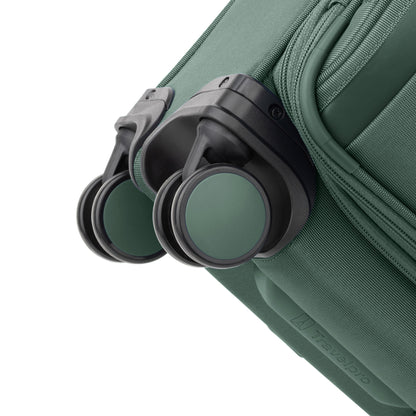 Close-up of the Travelpro® VersaPack®+ Compact Carry-on Expandable Spinner with green and black wheels.