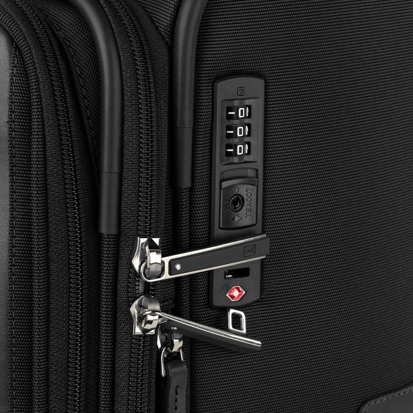Close-up of the Travelpro® VersaPack®+ Medium Spinner featuring a TSA lock and dual secure zippers.