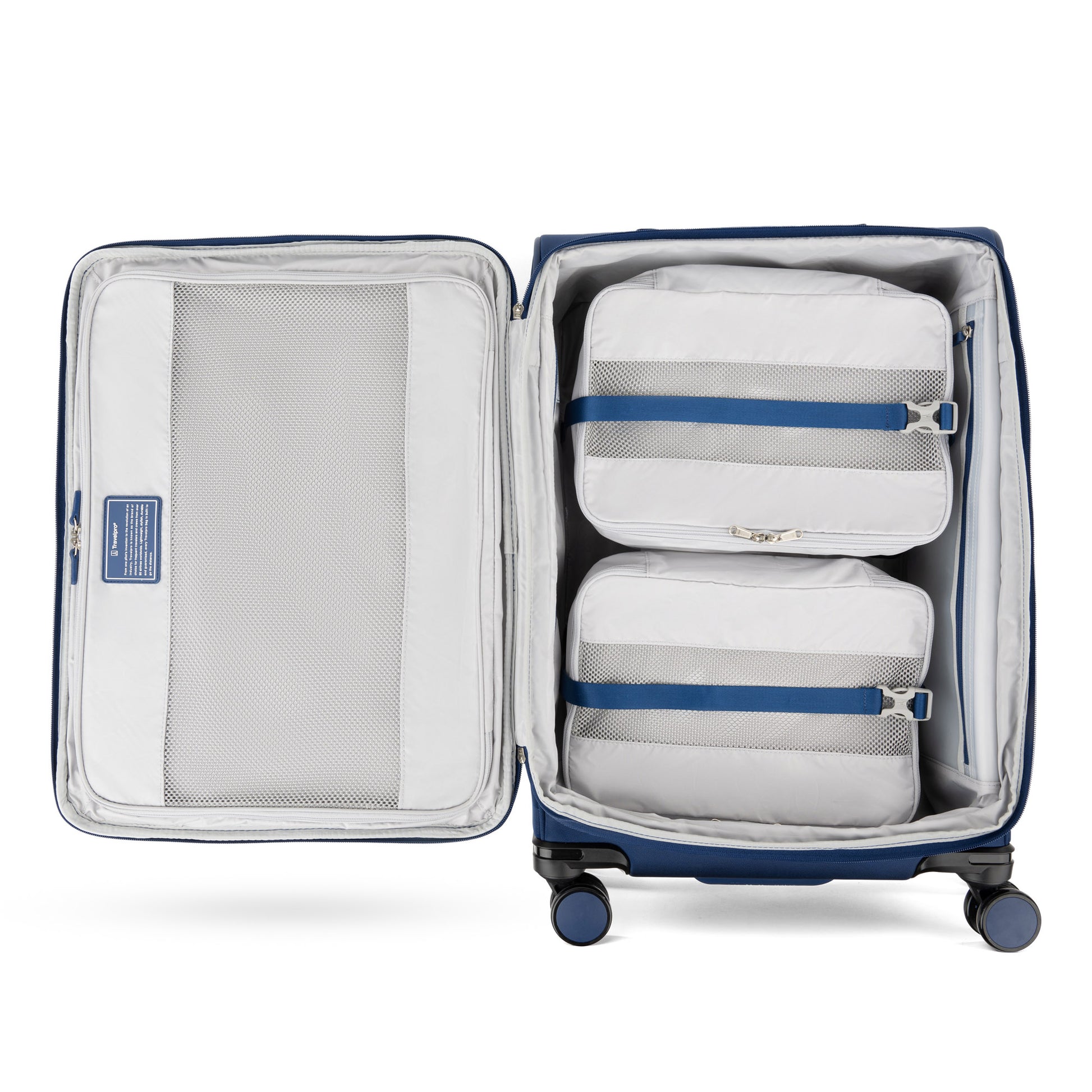 Travelpro VersaPack+ Medium Check-in Spinner in blue with water-resistant lining and two white packing cubes, top view.