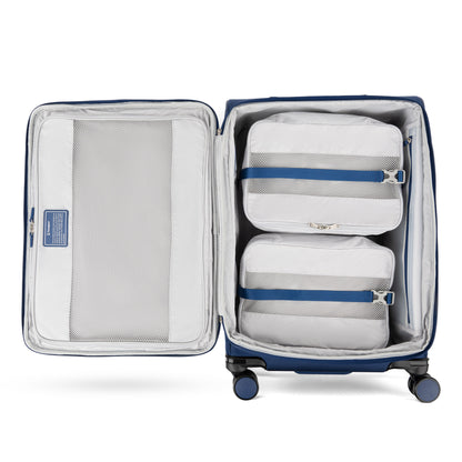Travelpro VersaPack+ Medium Check-in Spinner in blue with water-resistant lining and two white packing cubes, top view.