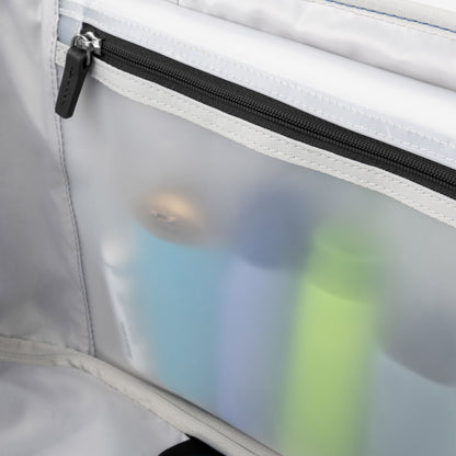 The Travelpro® VersaPack®+ Spinner's frosted zipper pocket securely holds bottles and personal items.