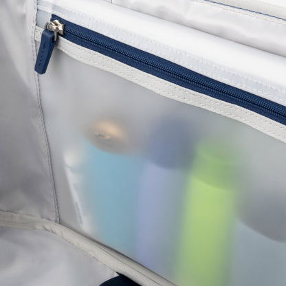Clear pocket with blue zipper fits travel toiletries—perfect with the Travelpro VersaPack+ Large Spinner luggage.