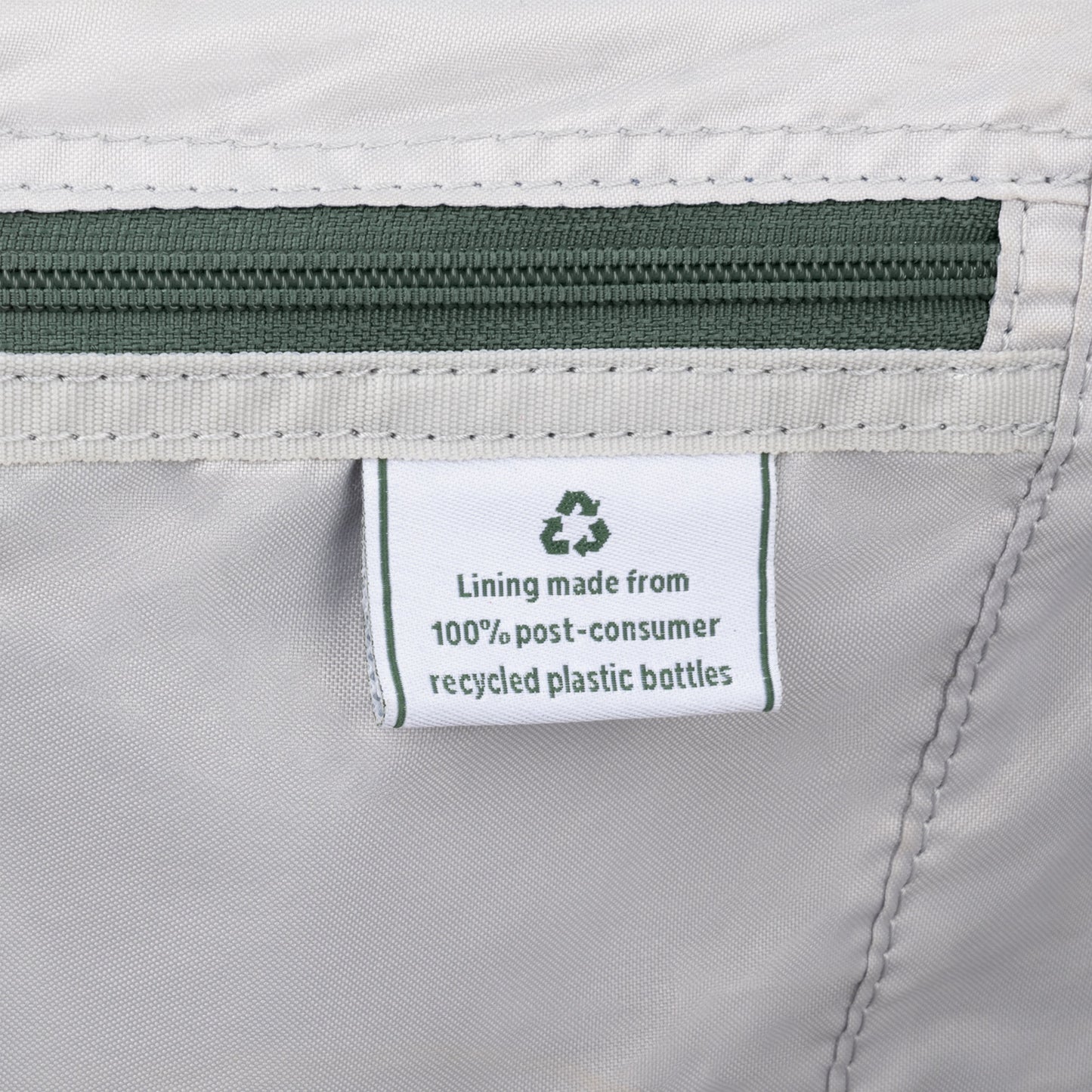 Close-up of Travelpro® VersaPack®+ tag: lining made from 100% post-consumer recycled plastic bottles.
