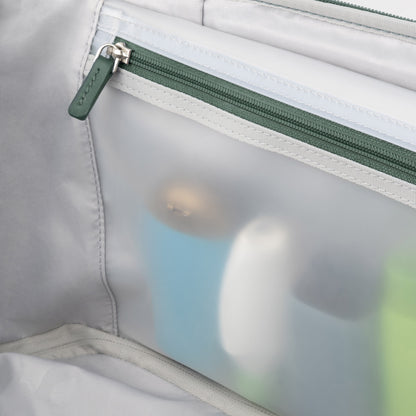 Close-up of a zippered pouch with travel toiletries for your Travelpro VersaPack+ Large Check-in Spinner.
