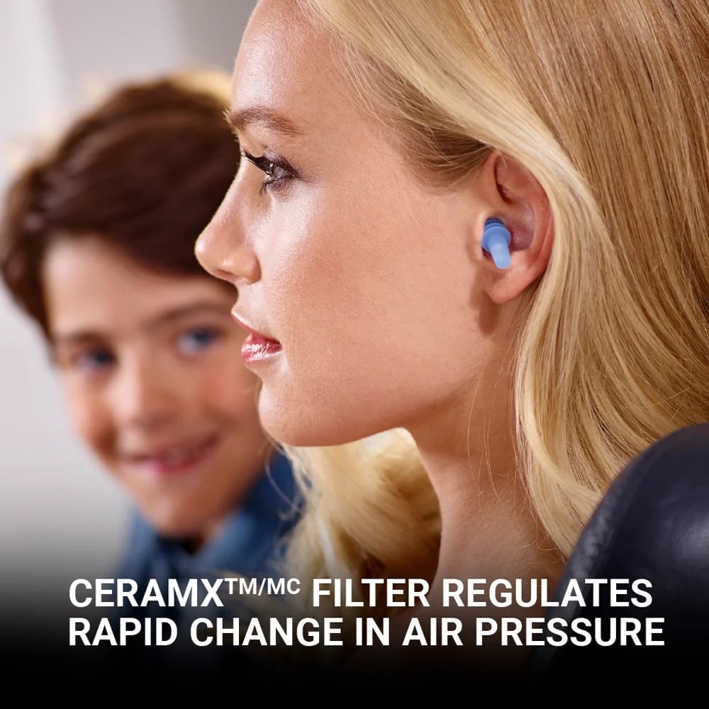 Woman wearing blue Go Travel Earplanes® sits by a child; CERAMX filter eases cabin pressure.