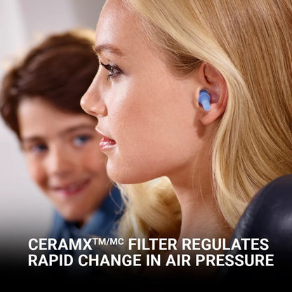 Woman wearing blue Go Travel Earplanes® sits by a child; CERAMX filter eases cabin pressure.