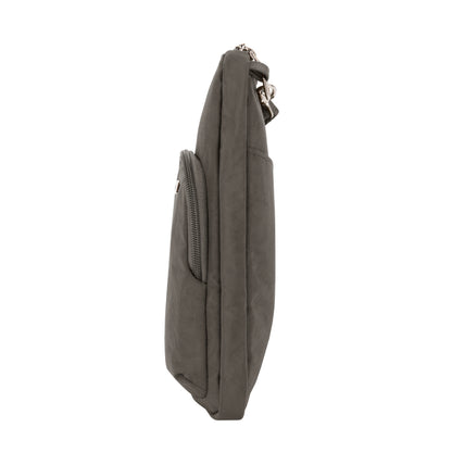 Side view of a slim, gray Travelon Anti-theft Essentials Mini Asymmetric Crossbody bag against a white background.