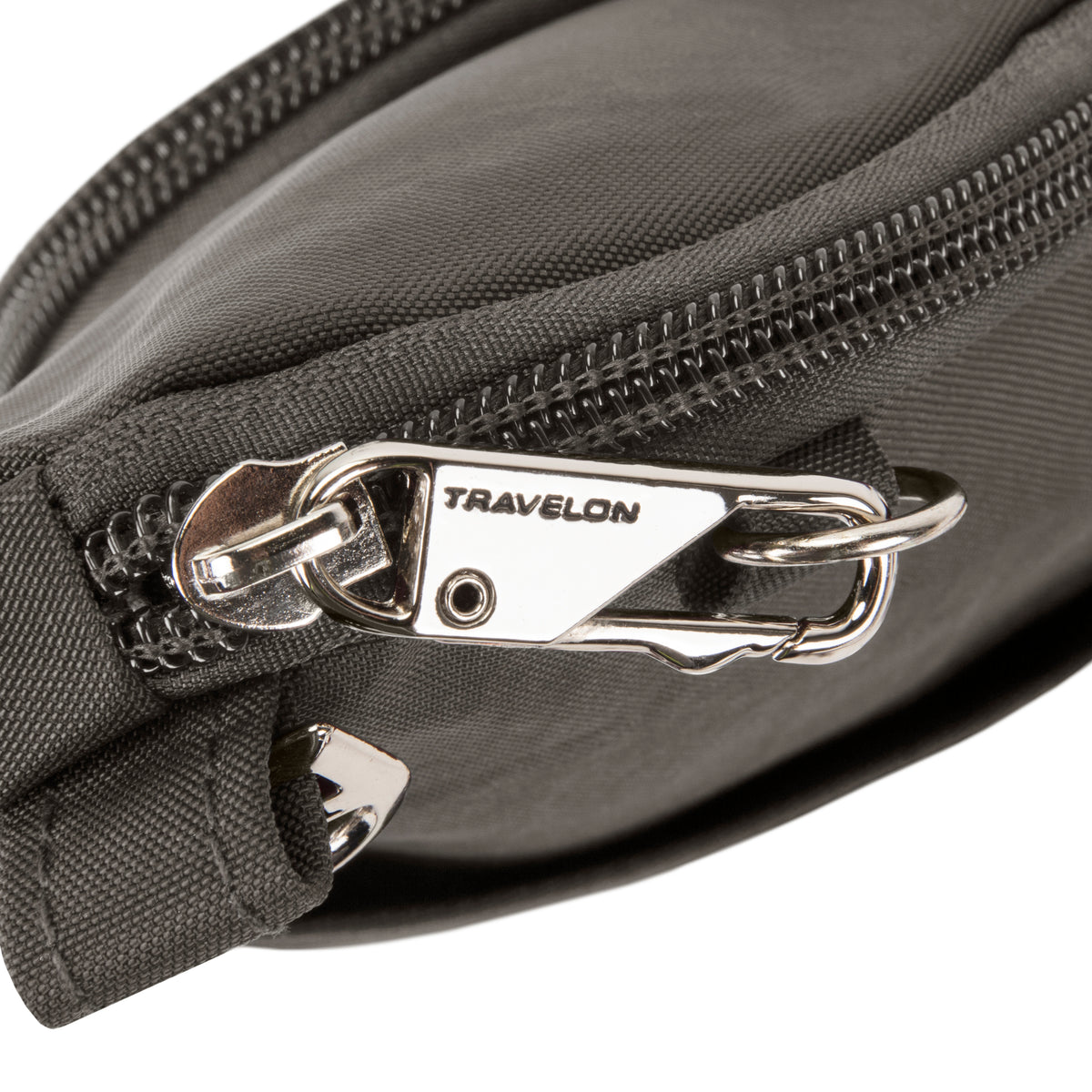 Close-up of Travelon Anti-theft Essentials Mini Asymmetric Crossbody, black with silver zipper pull and lock.