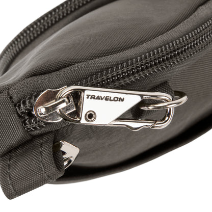 Close-up of Travelon Anti-theft Essentials Mini Asymmetric Crossbody, black with silver zipper pull and lock.