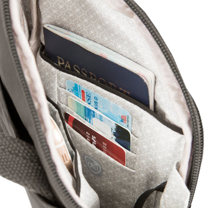 Open Travelon Anti-theft Essentials Mini Asymmetric Crossbody; interior pockets hold cards, passport, docs safely.