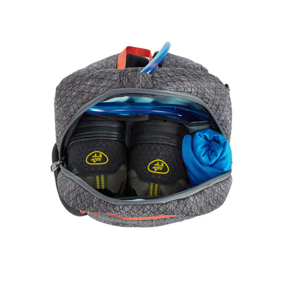 Open Travelon backpack with hiking boots, blue shirt, RFID organizer, and blue water bladder tube.