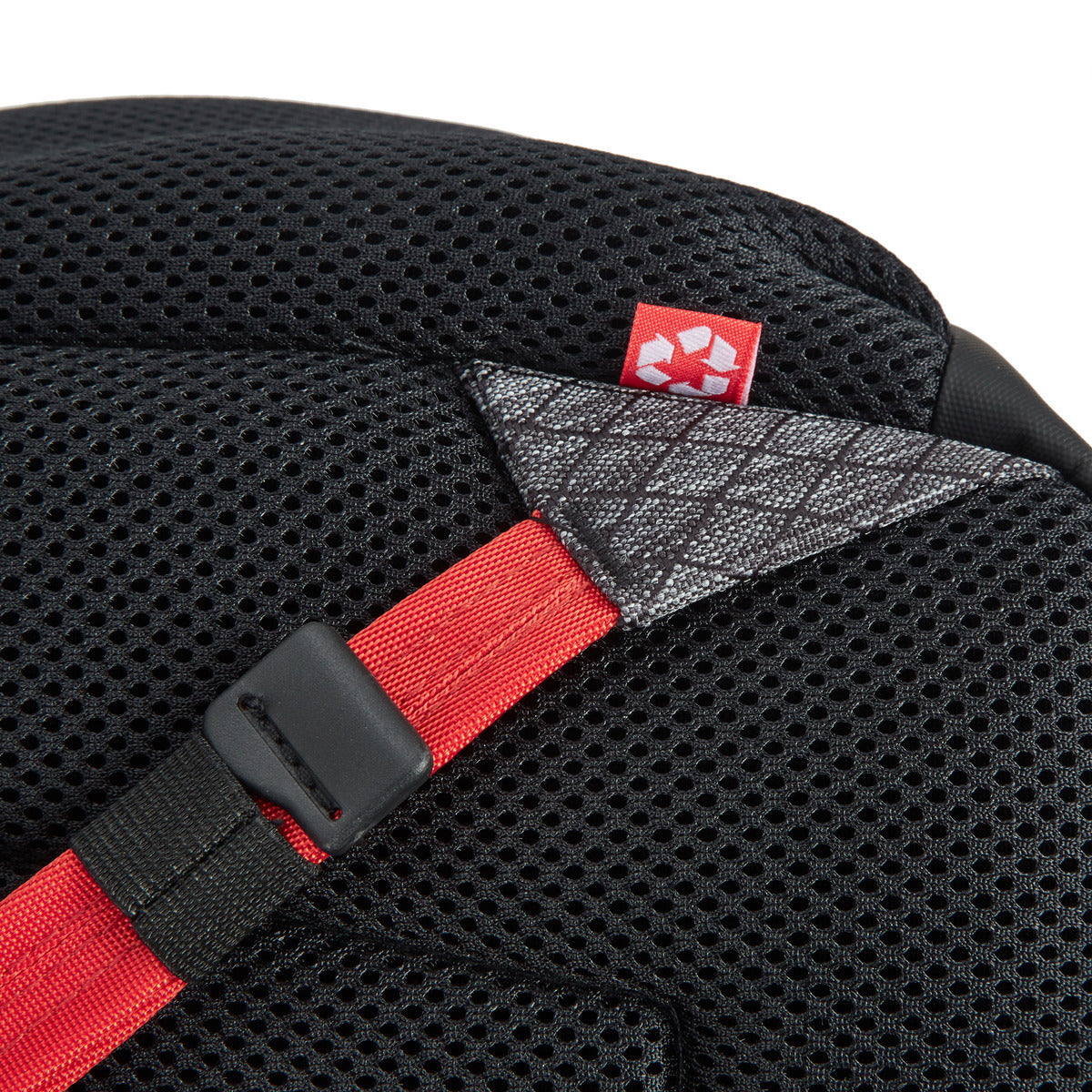 Close-up of the Travelon Anti-Theft Greenlander 9L Backpack, black mesh, red strap, small tag, RFID blocking organizer.