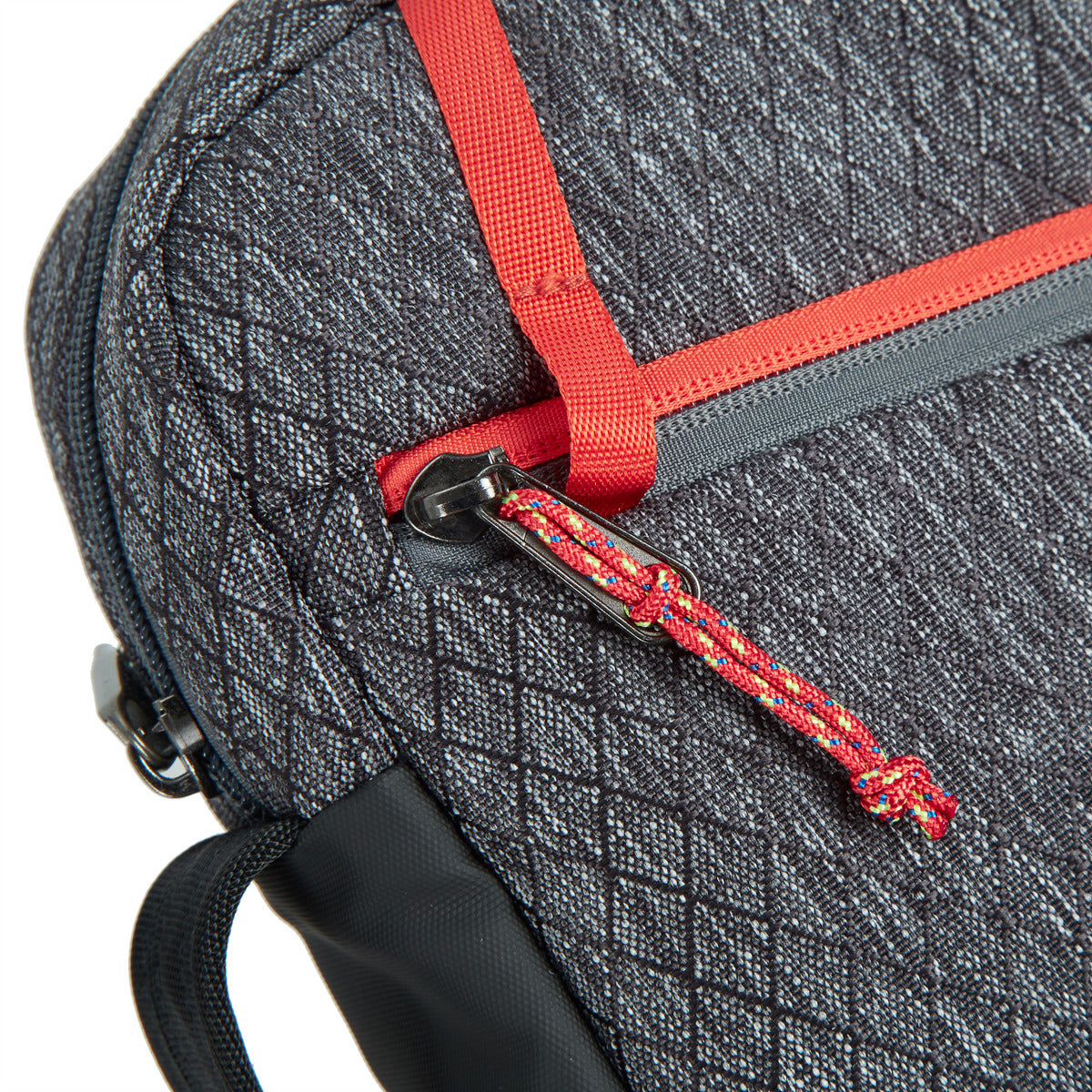 Close up of red zipper pull string on the Travelon Anti-Theft Greenlander Small Crossbody in diamond ash grey