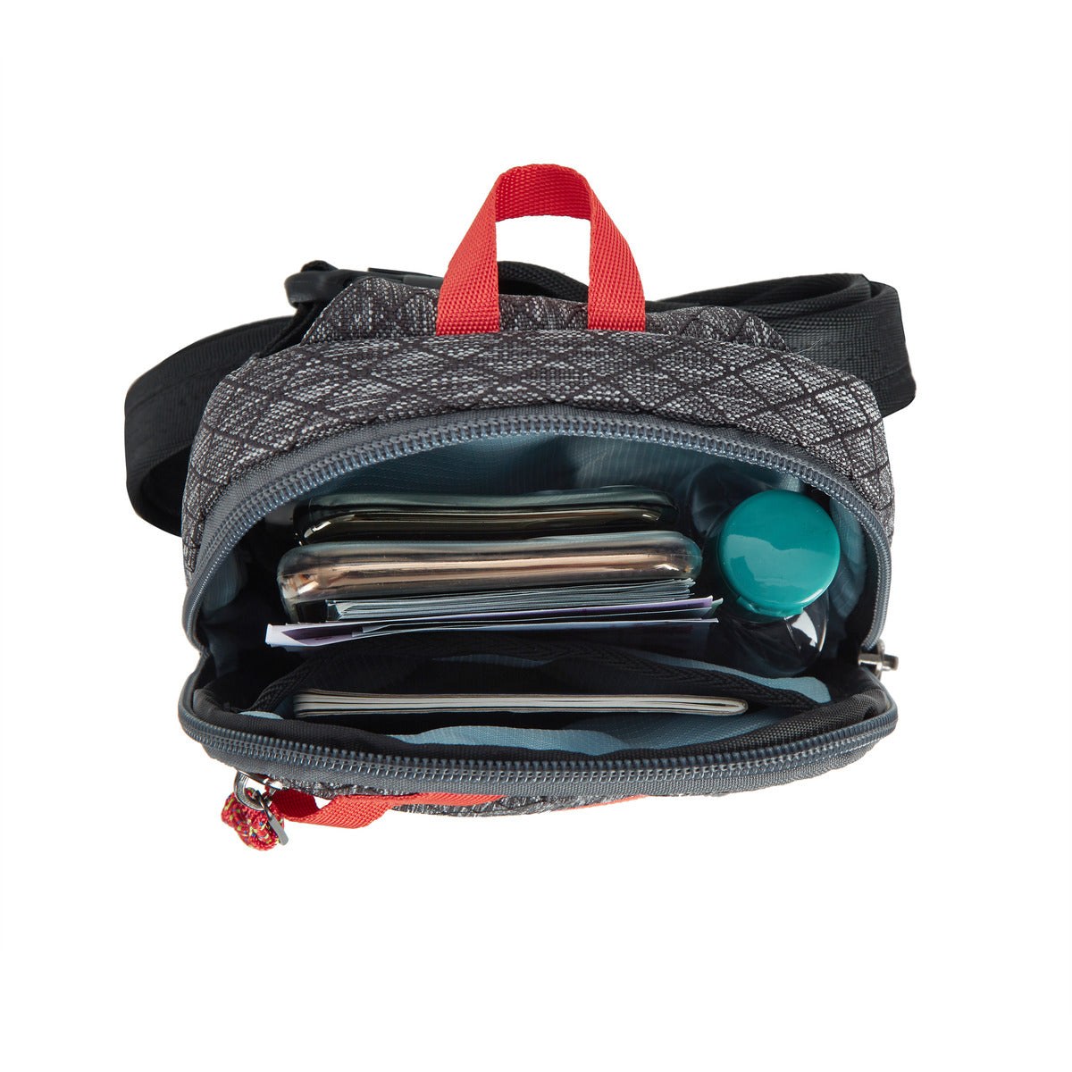 Open Travelon's Anti-Theft Compact Sling showing phones, wallet, and a round recycled item inside.