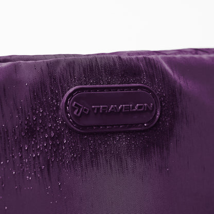 Close up of Travelon logo on front of blackberry Pi Everyway Phone Sling/Belt Bag with water droplets