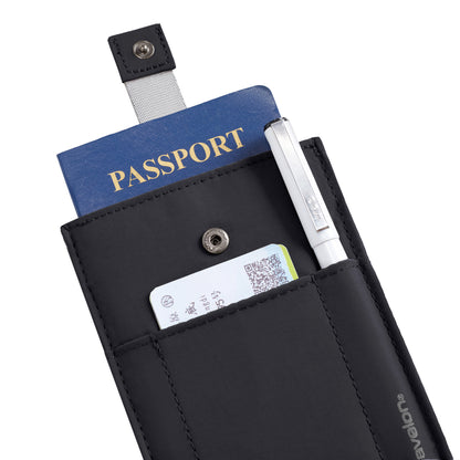 The Travelon RFID Blocking Pull-Up Passport Holder in black holds a blue passport, pen, and boarding pass.