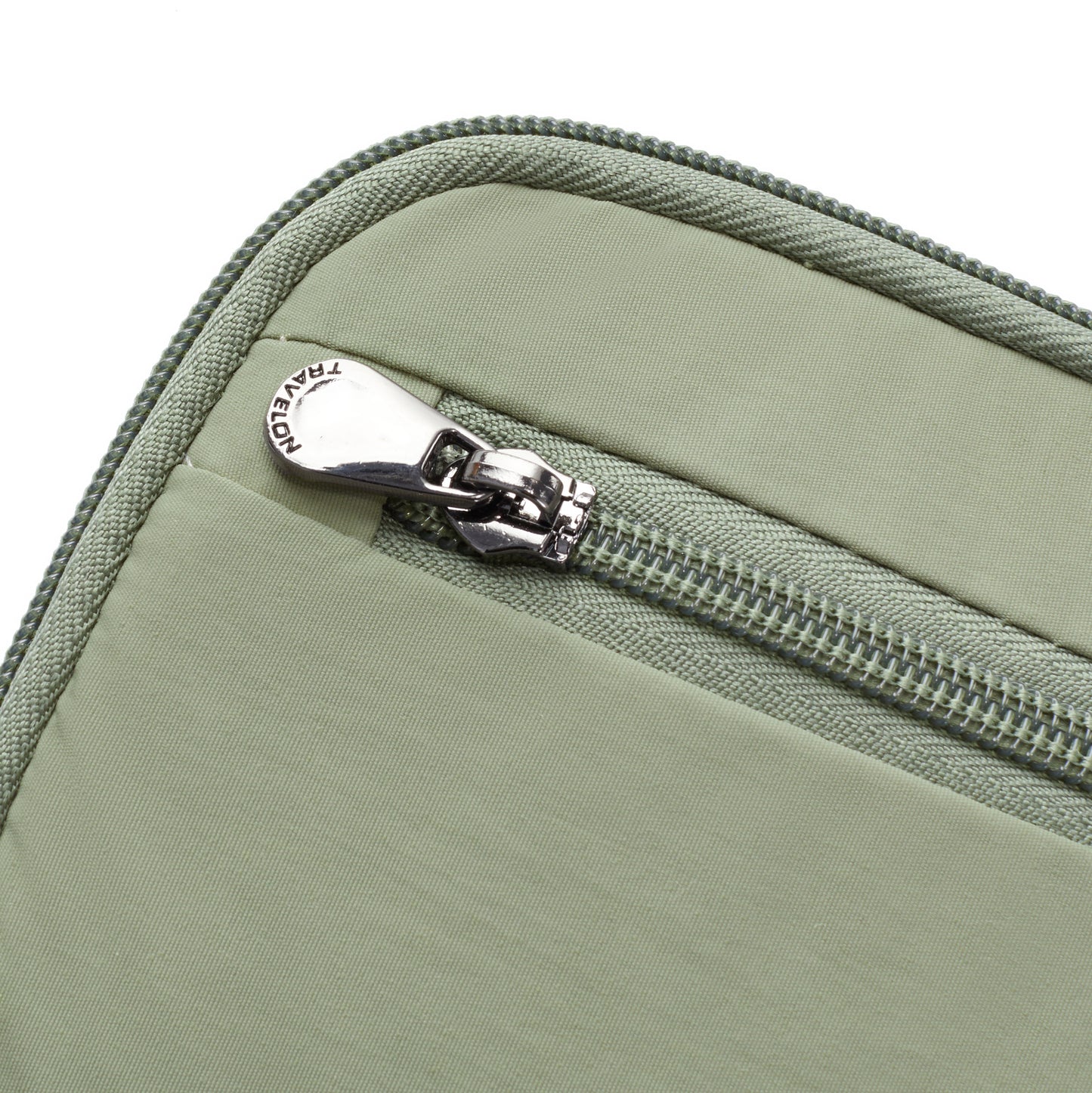 Close-up of the Travelon RFID Blocking Zip Passport Wallet in light green, featuring a zipper and metal pull tab.