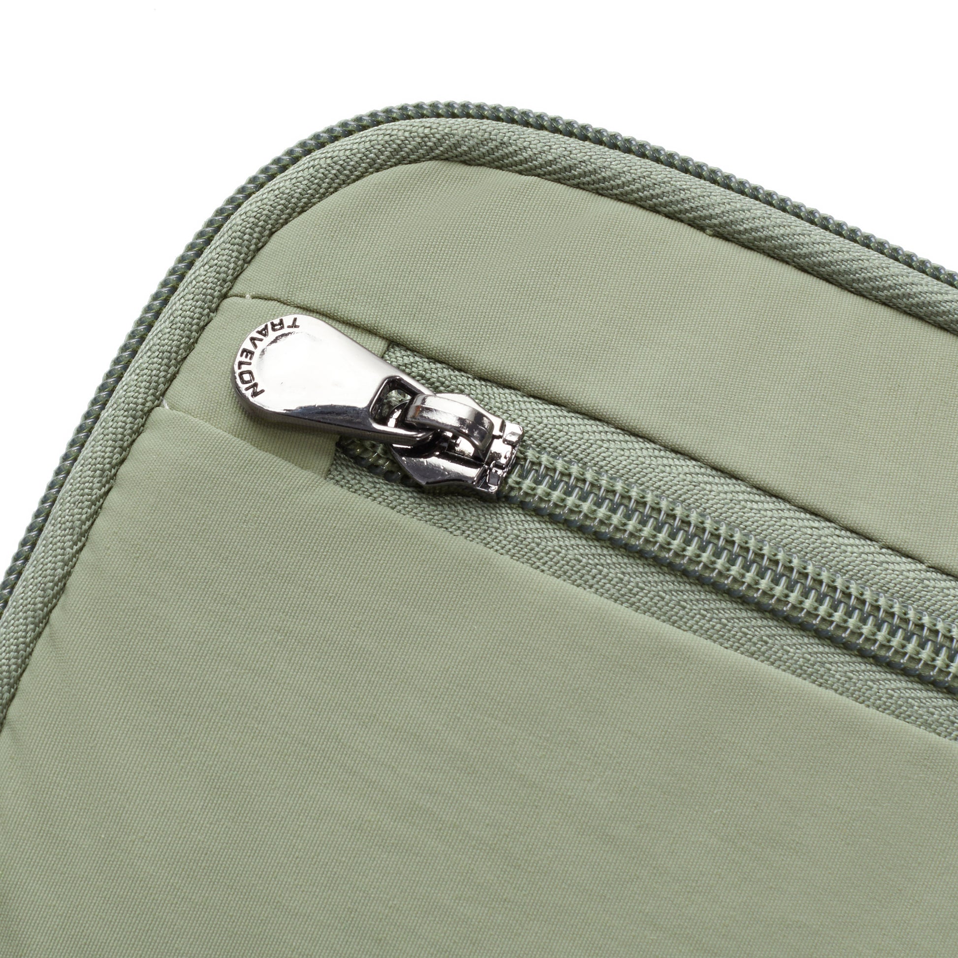 Close-up of the Travelon RFID Blocking Zip Passport Wallet in light green, featuring a zipper and metal pull tab.