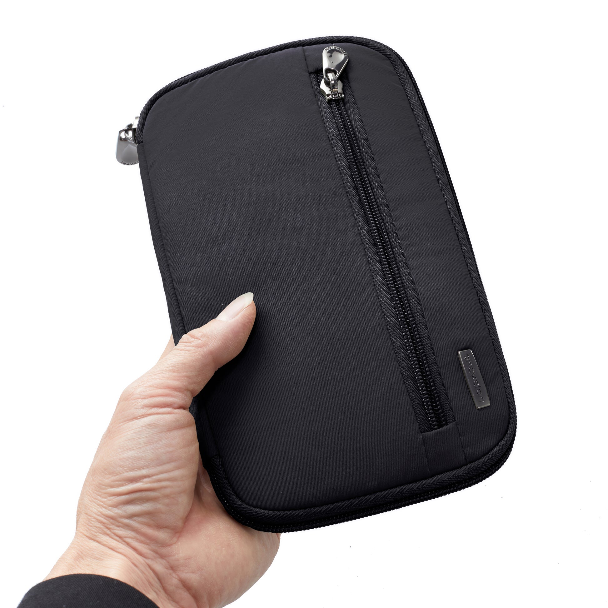 A hand holds the Travelon RFID Blocking Zip Passport Wallet by Travelon against a white background.