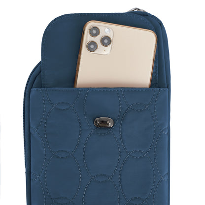 A gold smartphone is partially inserted into the front pocket of a Travelon Runways Slim Asymmetric Crossbody.