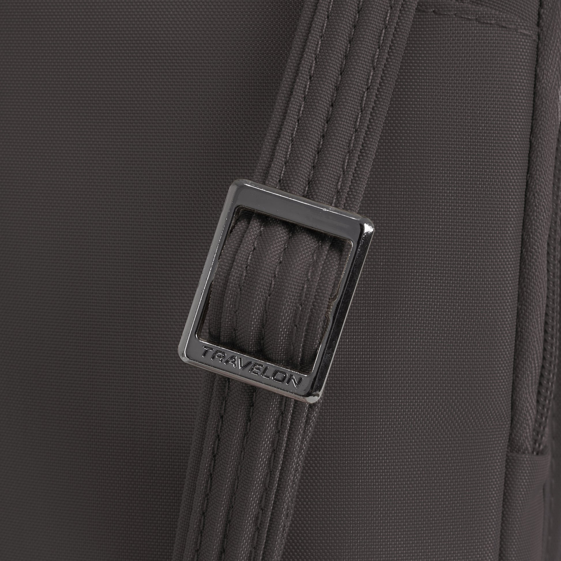 Close-up of the gray strap on the Travelon Runways Anti-theft Slim Asymmetric Crossbody with a silver buckle.
