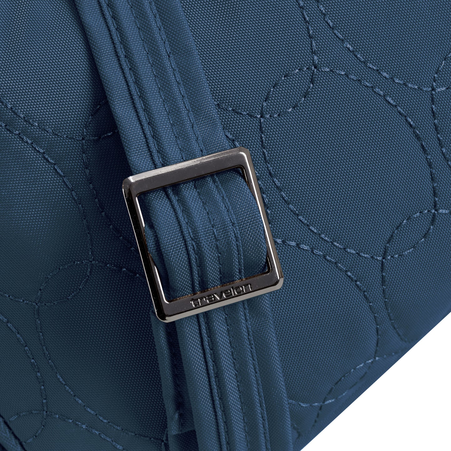Close-up of the Travelon Runways Anti-theft Double Compartment Crossbody in blue with a metal buckle and stitching.