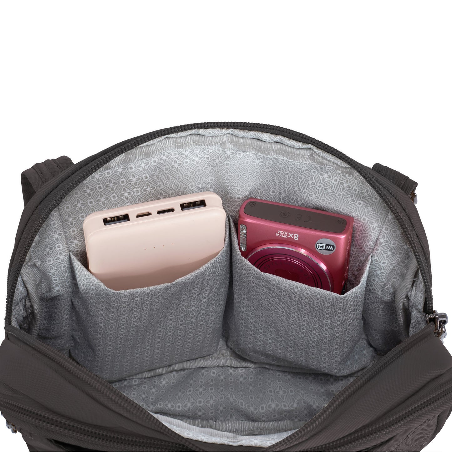 Open Travelon Runways Crossbody to reveal two inner pockets with a pink power bank and red digital camera.