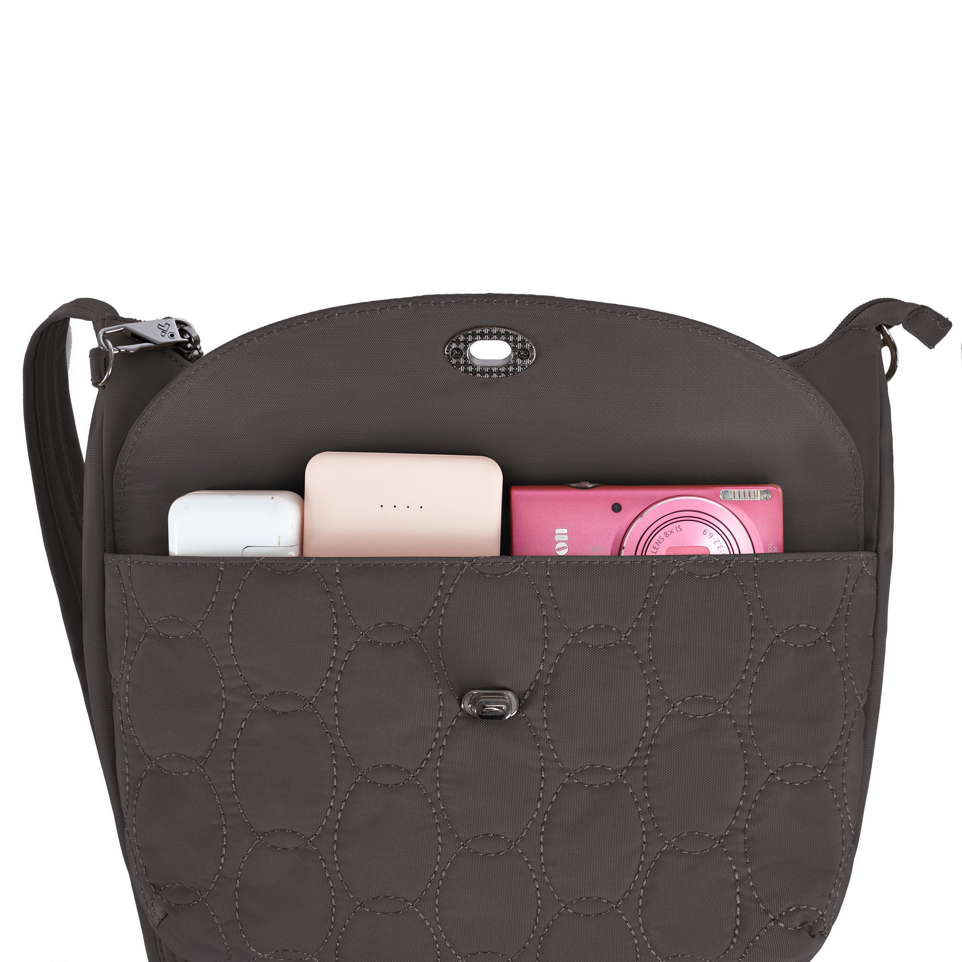 Open Travelon Runways Anti-theft Crossbody shows a white case, pink device & power bank in the front pocket.