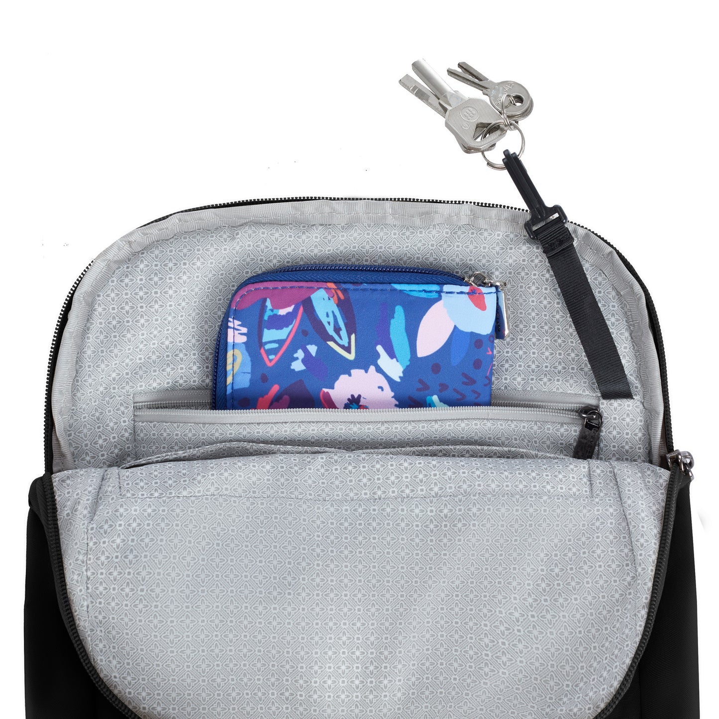 Open Travelon Runways Anti-theft Compact Backpack to reveal a blue floral pouch inside and keys on a leash.