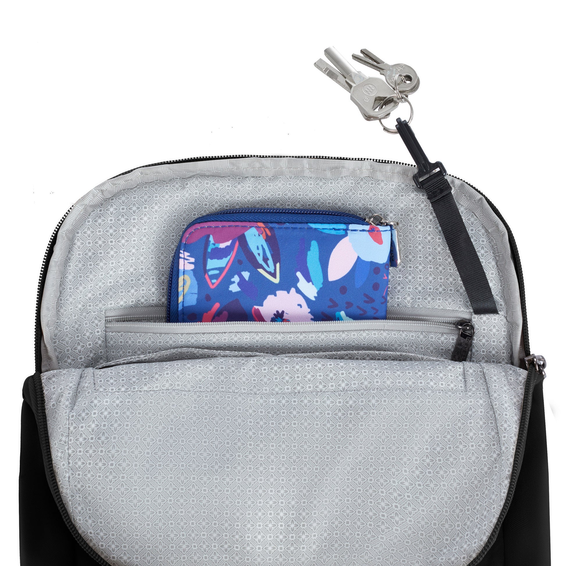Open Travelon Runways Anti-theft Compact Backpack to reveal a blue floral pouch inside and keys on a leash.