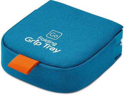 Go Travel Folding Grip Tray: blue fabric tray with orange pull tab, white text, and non-slip drink holder.