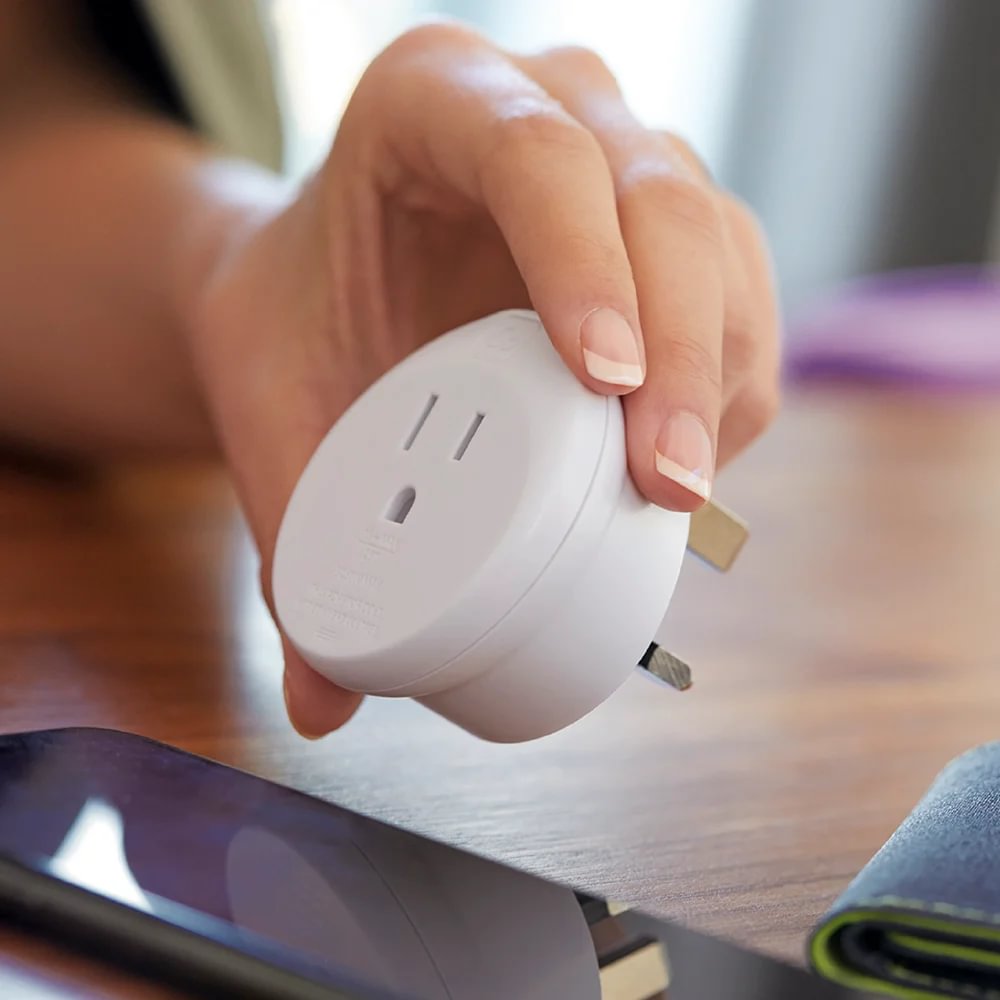 Hand holding Go Travel Americas-UK Grounded Adapter, ideal for American and Canadian travellers.