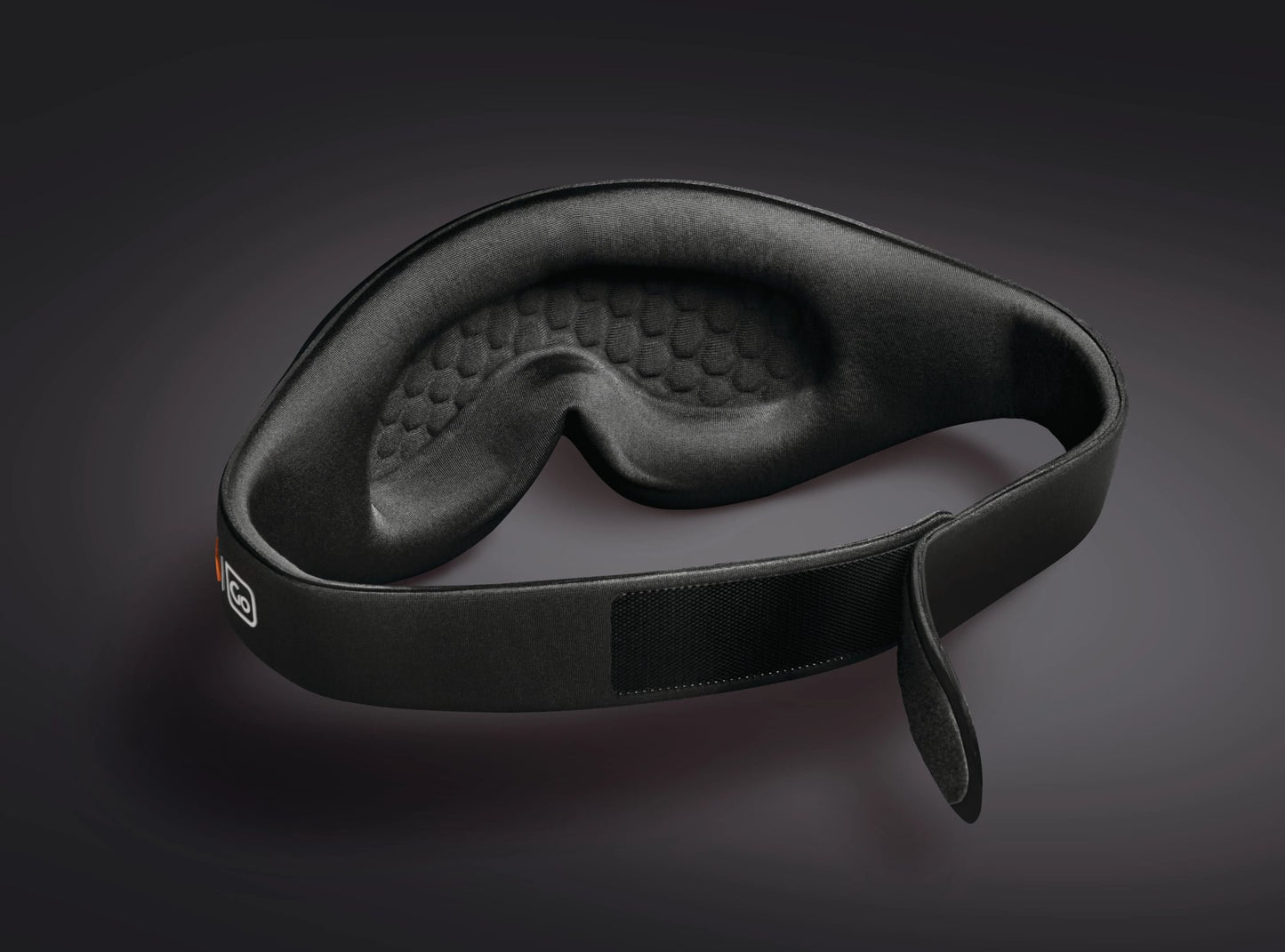 Go Travel The Ultimate Eye Mask by Go Travel with adjustable Velcro strap shown on a dark background.