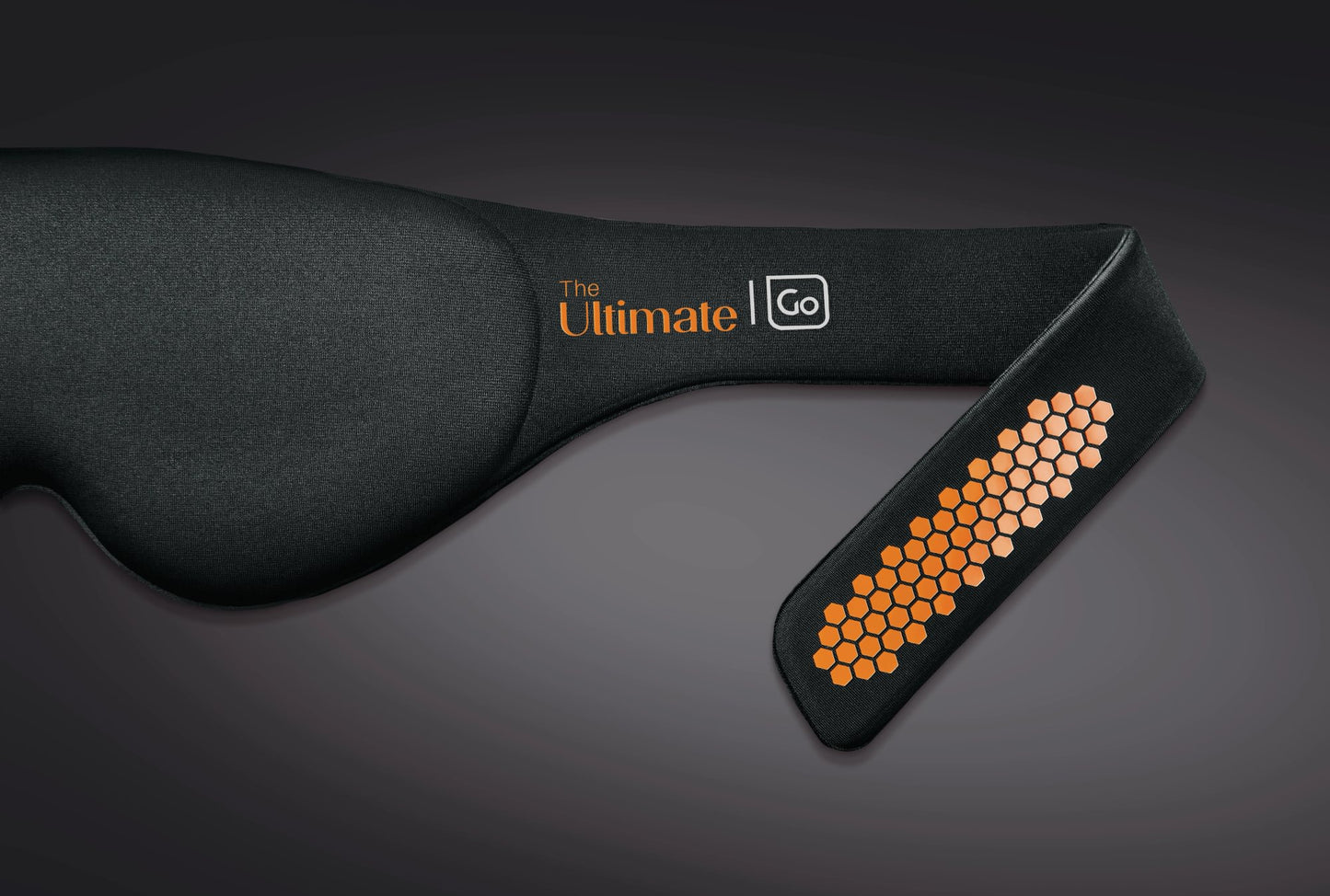 Go Travel The Ultimate Eye Mask is a black sleep mask with orange honeycomb on an adjustable strap.