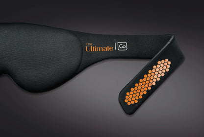 Go Travel The Ultimate Eye Mask is a black sleep mask with orange honeycomb on an adjustable strap.